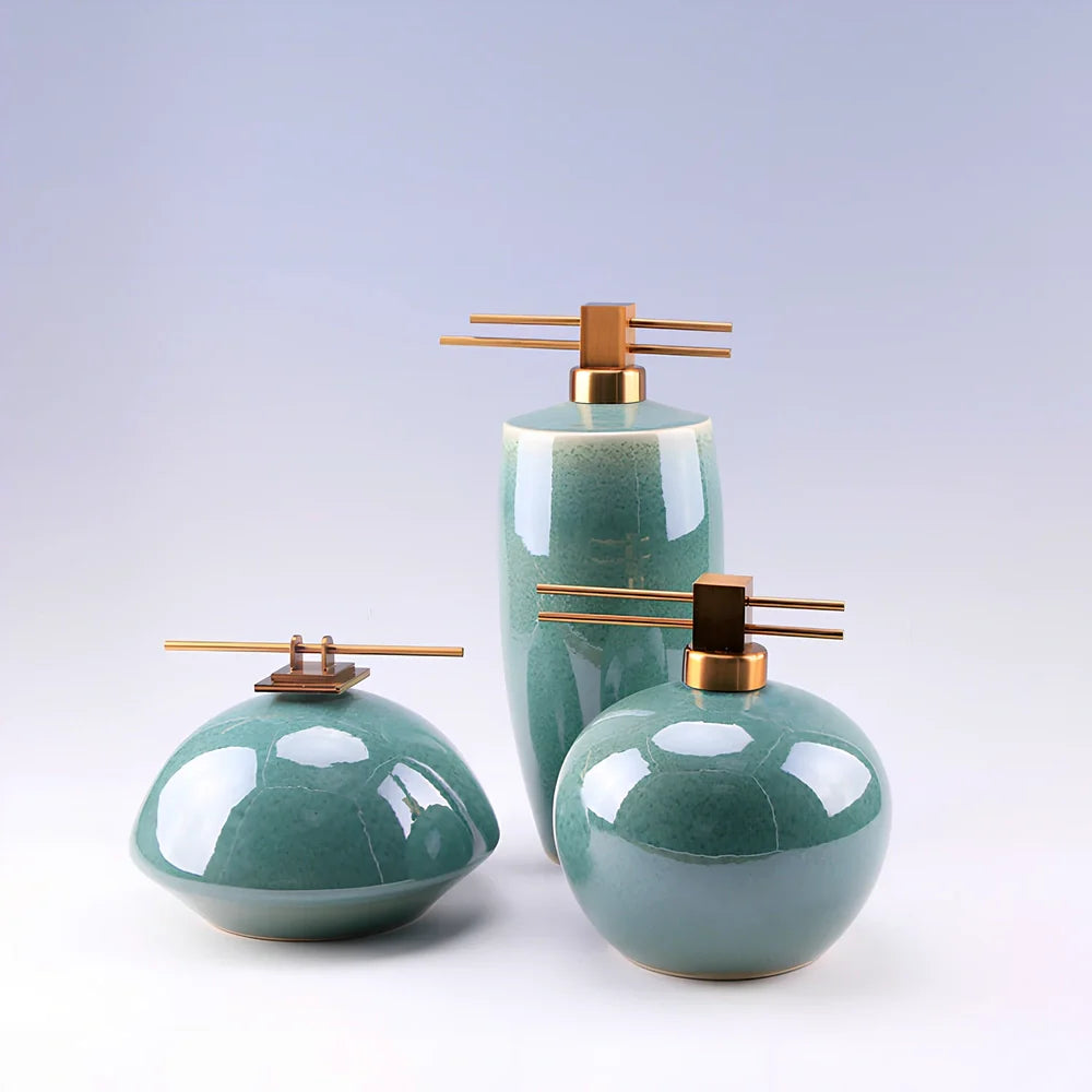 Handmade ceramic ornaments in graduated sizes with emerald green and golden sunlight glazes