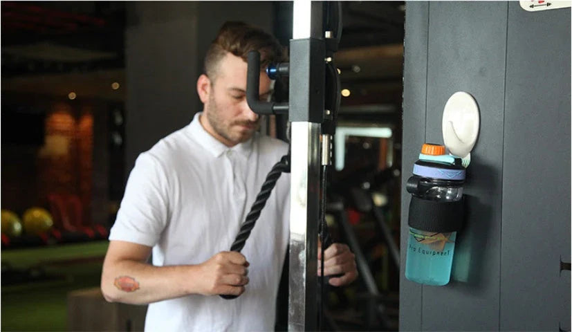 Magnetic sports water bottle with adjustable silicone grip that securely attaches to metal surfaces for hands-free hydration during workouts and outdoor activities