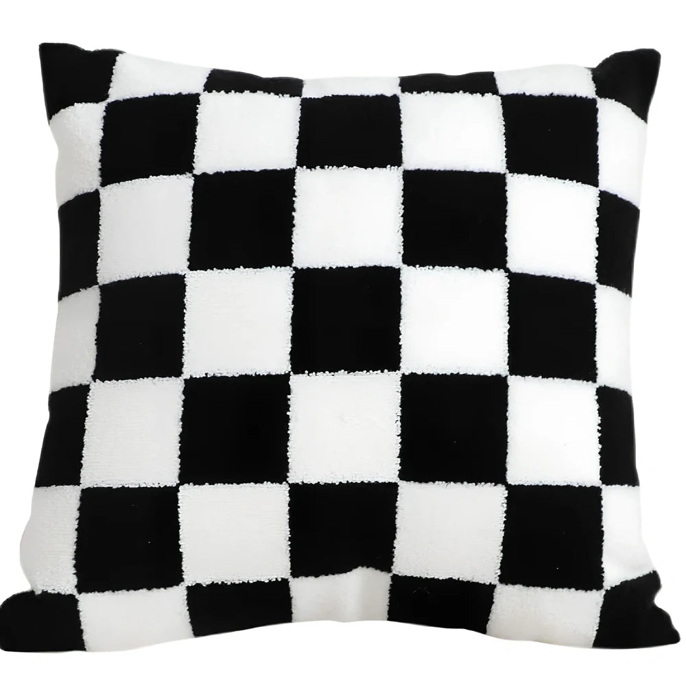 Black and white checkerboard square pillow measuring 45cm on sofa