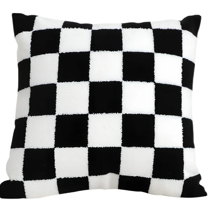 Black and white checkerboard square pillow measuring 45cm on sofa