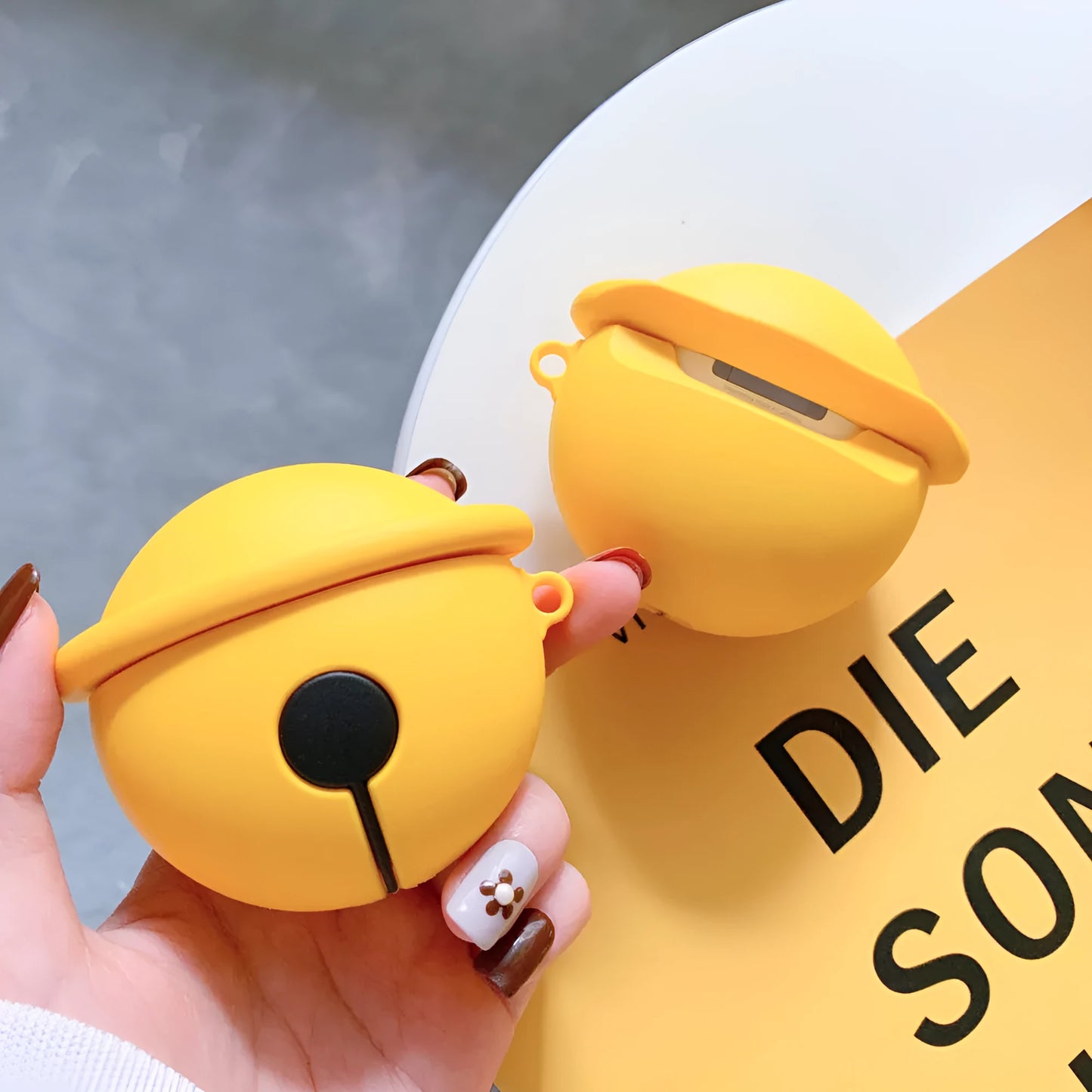 Yellow silicone bell-shaped case for AirPods with keychain loop