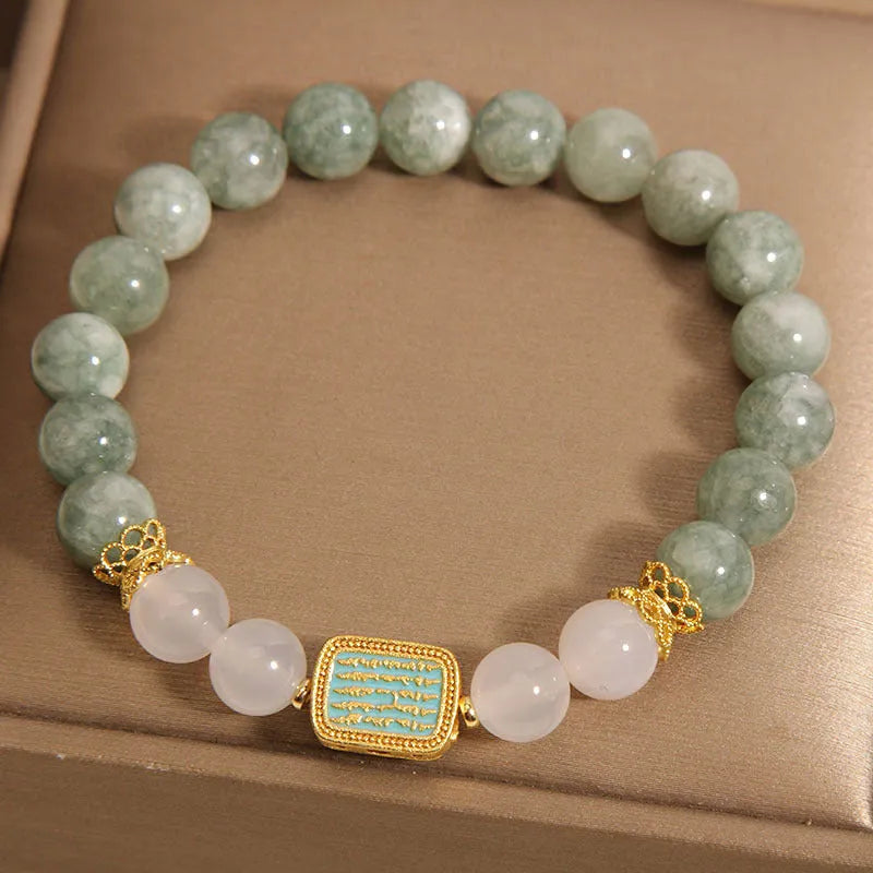 Women's bracelet with five oil green emerald crystal stones in a scripture charm design.
