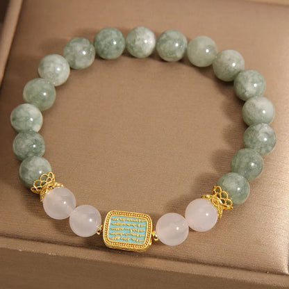 Women's bracelet with five oil green emerald crystal stones in a scripture charm design.