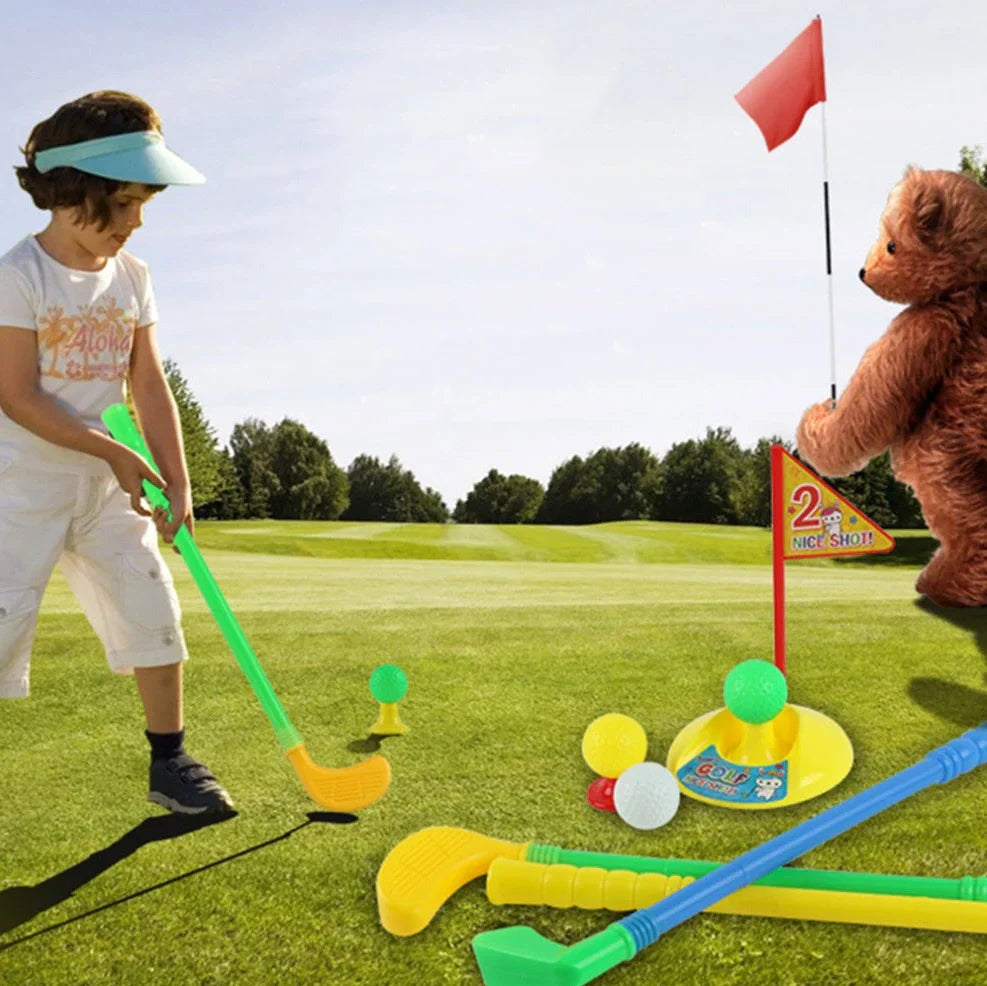 Children's golf set with three clubs, three balls, putting hole with flag, and adjustable tees on green surface