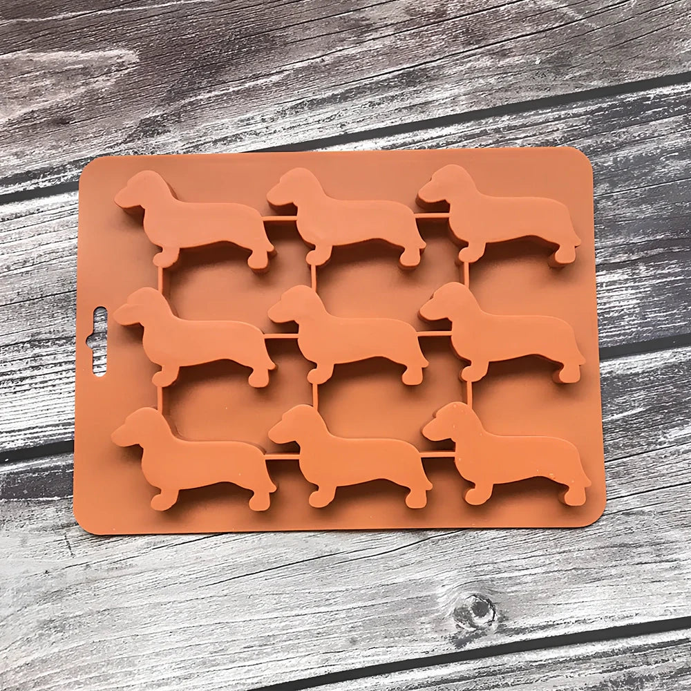 Orange silicone ice mould with 12 animal-shaped compartments for making decorative ice cubes