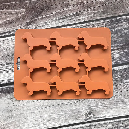 Orange silicone ice mould with 12 animal-shaped compartments for making decorative ice cubes