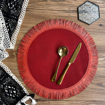 Round handwoven jute placemat with decorative tassels measuring 30cm diameter in Christmas green colour