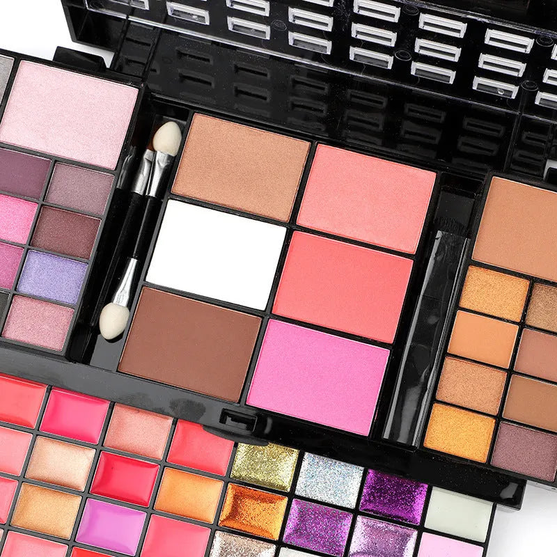 74 colour makeup palette open to show eyeshadows, lip glosses, and face powders with included brushes