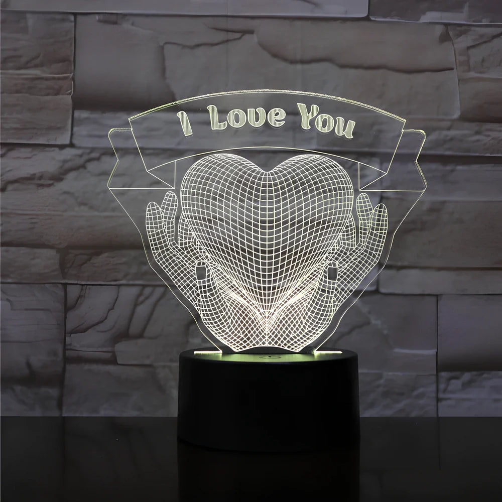 3D acrylic night light with hands holding heart design, showing seven colour options and remote control