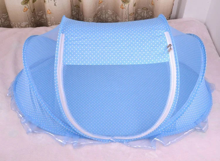 Portable foldable baby bed net with built-in mattress and pillows, perfect for travel and outdoor activities