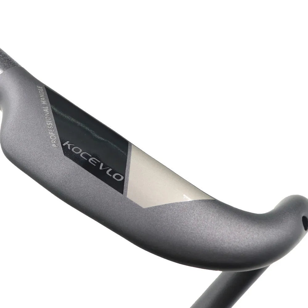 Matte black carbon fibre road bike drop handlebar showing bent shape.