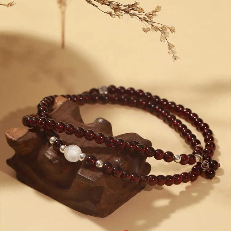 Handmade antique Chinese style bracelet with red imitation garnet and pomegranate design in a gift box.