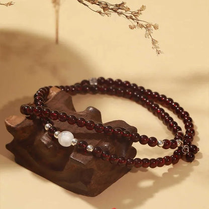 Handmade antique Chinese style bracelet with red imitation garnet and pomegranate design in a gift box.