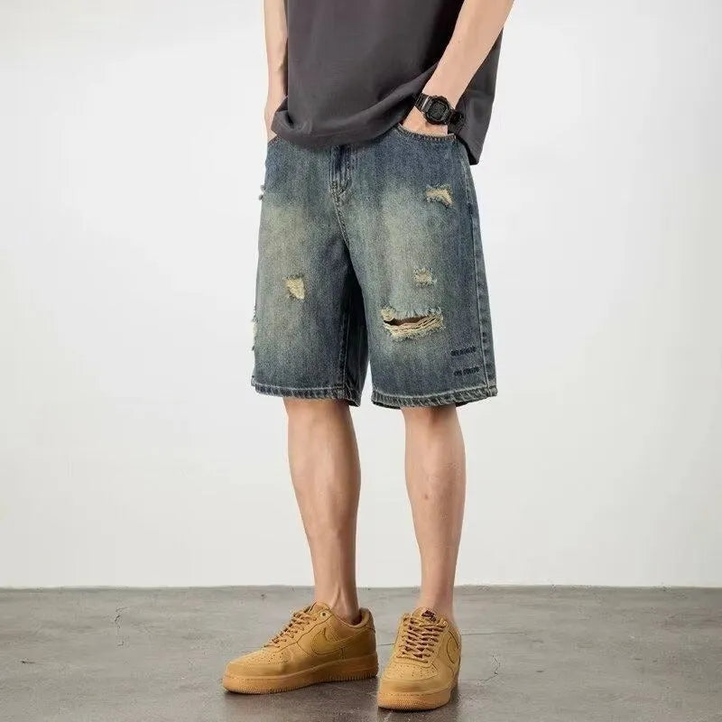 Men's blue distressed denim shorts with loose hole detailing and straight leg cut
