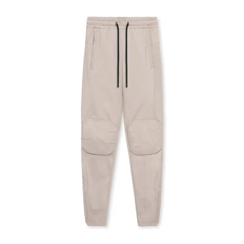 Men's grey fitness trousers with ankle ties, made from quick-drying polyester, for exercise and casual use.