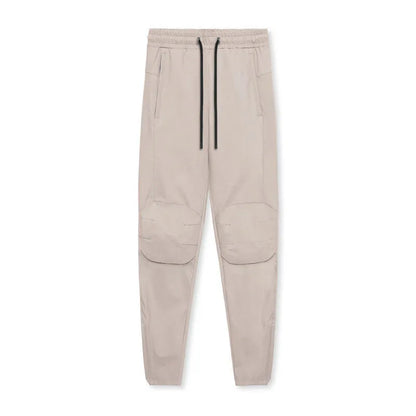 Men's grey fitness trousers with ankle ties, made from quick-drying polyester, for exercise and casual use.