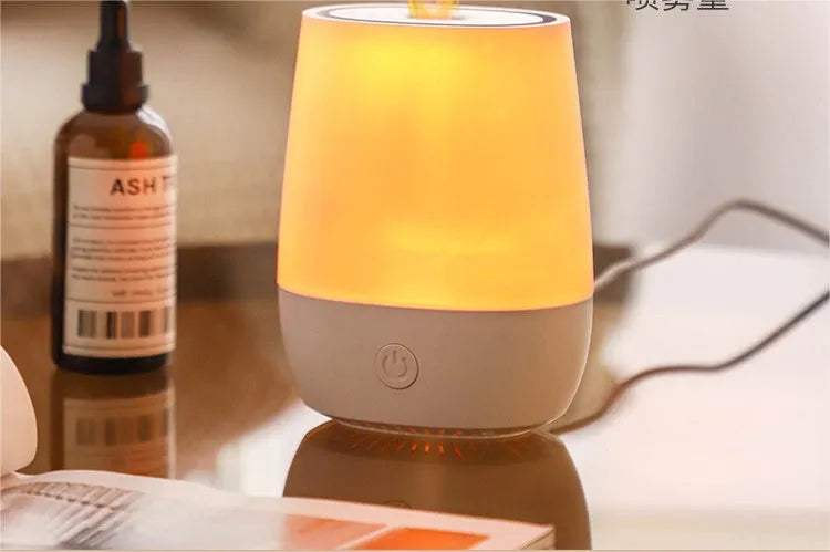 White USB aroma diffuser humidifier with simulated flame light effect on a table.