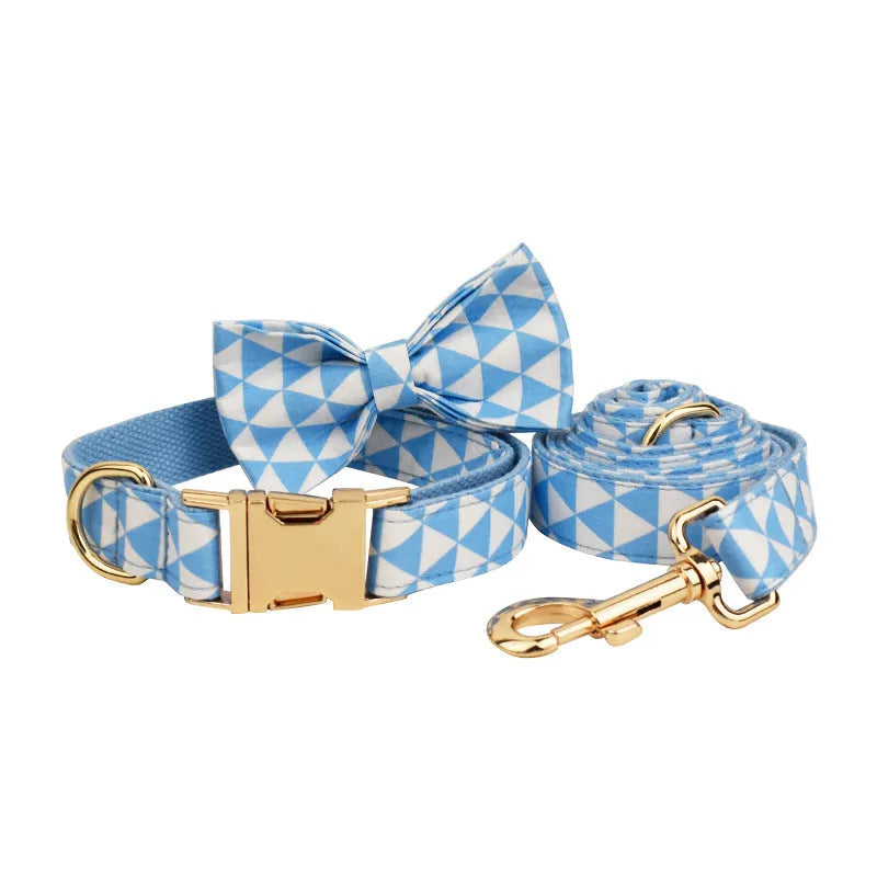 Blue cloth dog collar, leash, bow, and vest four-piece set with triangular metal ring, shown in a pet accessory bundle.