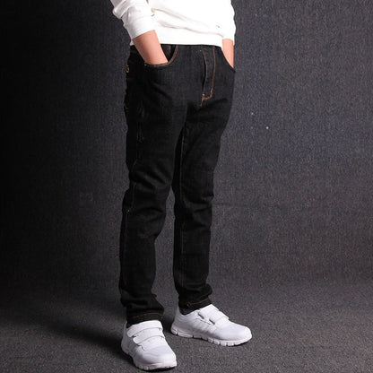 Boys' black micro-stretch cotton jeans showing 4-way flexibility and middle waist design