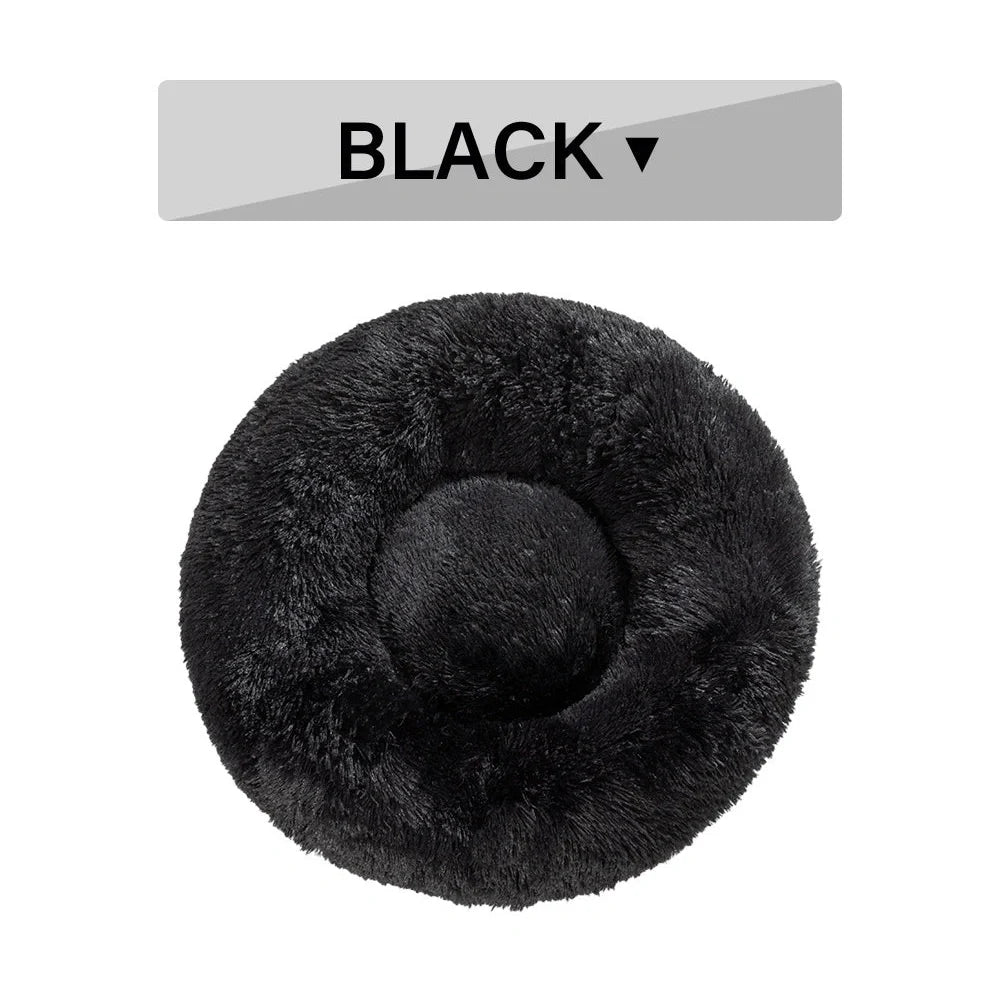 Fluffy donut-shaped dog bed in dark grey colour with raised edges, showing plush texture and circular design