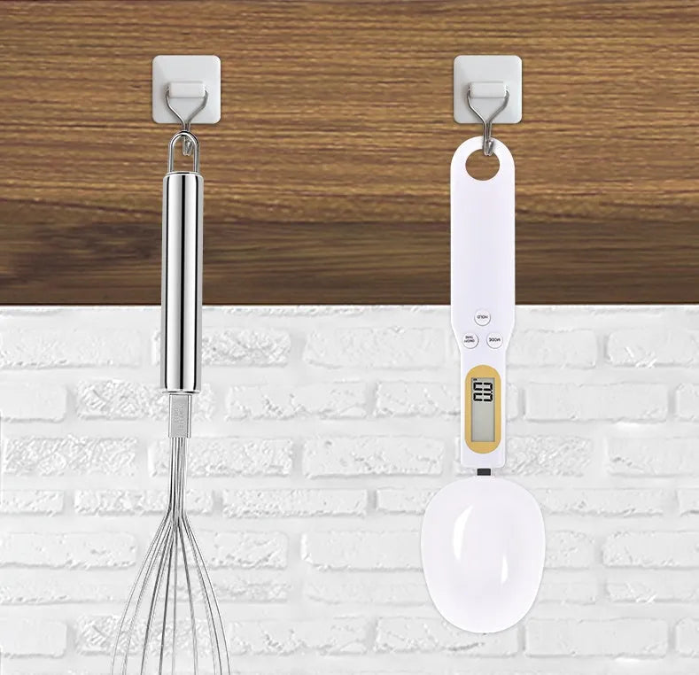 Black electronic measuring spoon scale showing digital display with spoon bowl for kitchen weighing