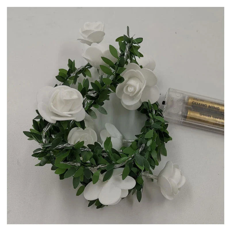 Enchanting rose vine string lights with warm white LED illumination and natural green leaves and rose buds
