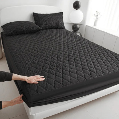 Diamond lattice quilted bamboo fibre mattress protector set in solid colour on a bed.