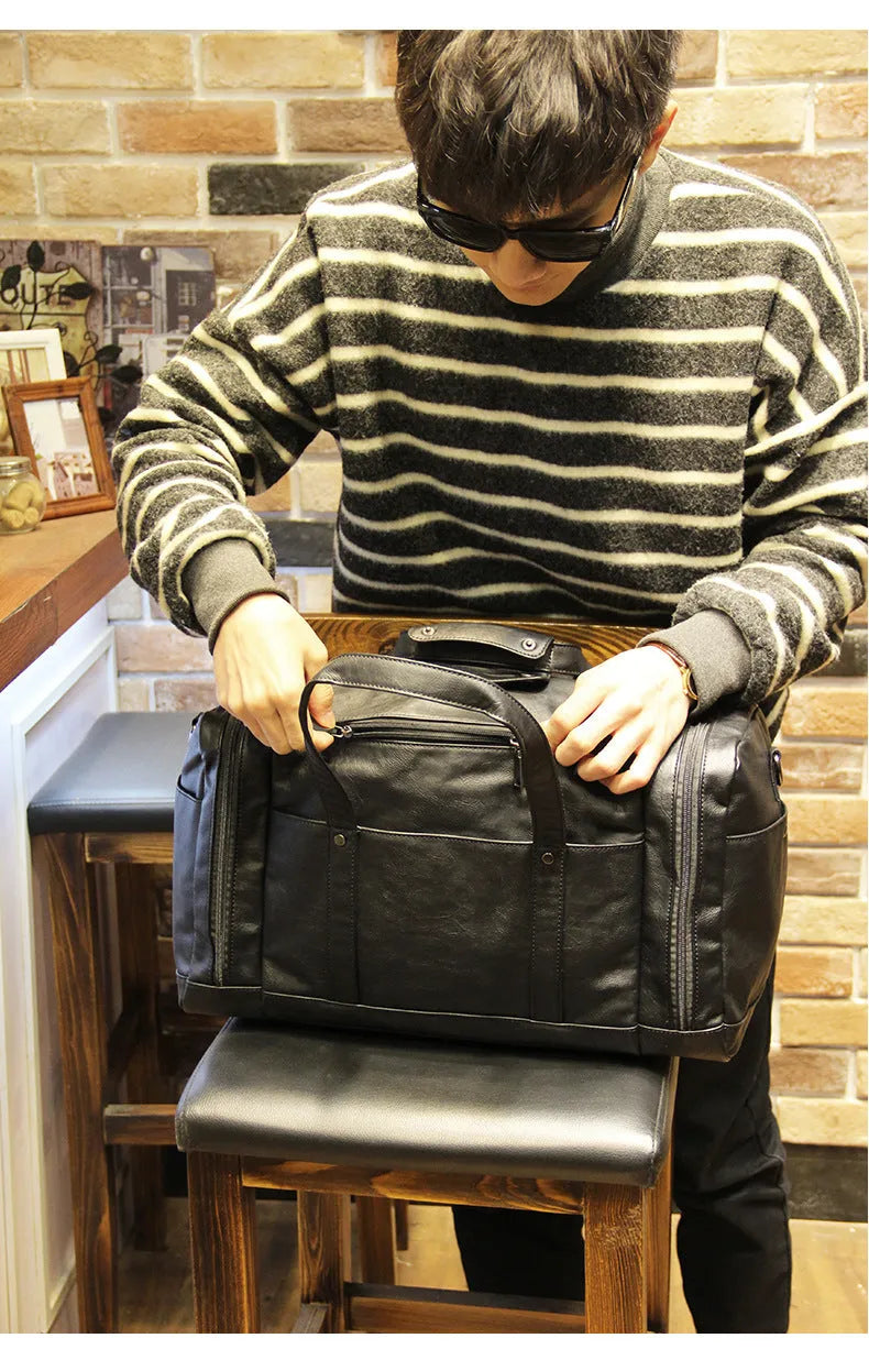 Black PU men's travel bag, 50cm wide and 26cm high, with phone, cigarette, and hidden zipper bags