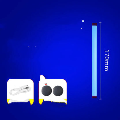 Blue rechargeable LED light tube with USB plug and push-button switch on a dark surface