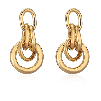 Geometric gold-coloured copper earrings with irregular asymmetric design