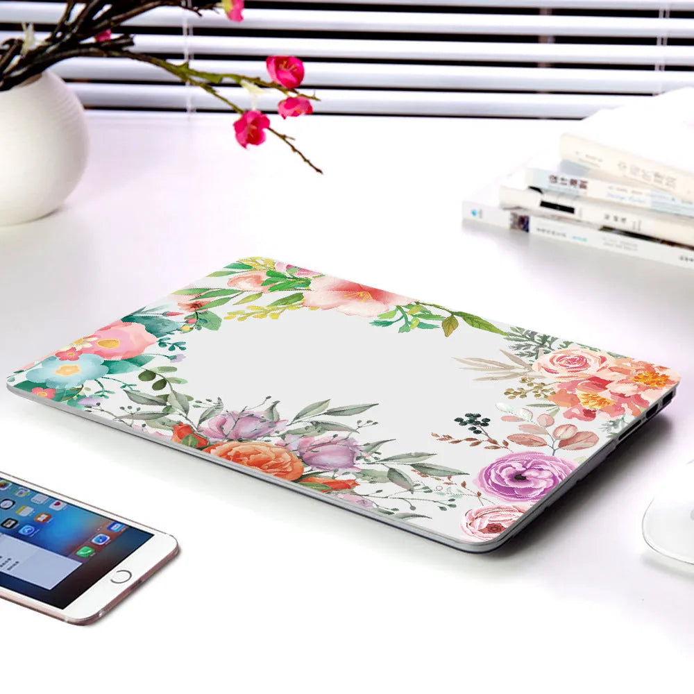 Plastic protective shell with floral pattern for Apple MacBook laptop showing sampling flower design