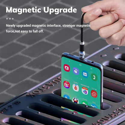 Black spherical magnetic charging cable with rotating head next to iPhone and Android phones