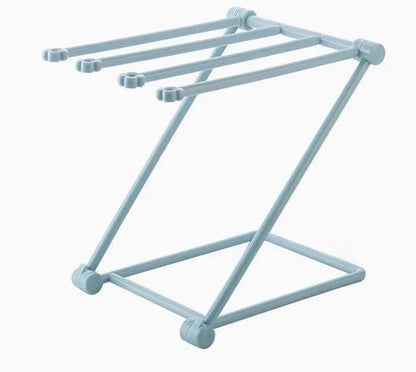 Foldable plastic dishcloth shelf organiser in Nordic style mounted on a kitchen wall