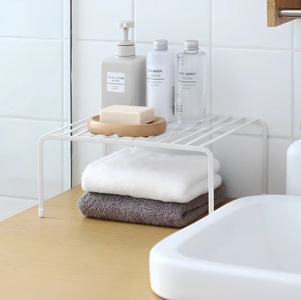 White retractable kitchen shelf extended to 60cm with spices and oils organised on metal surface