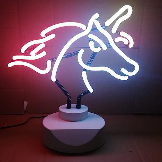 Unicorn-shaped neon light on desk with purple illumination, showing wall bracket option