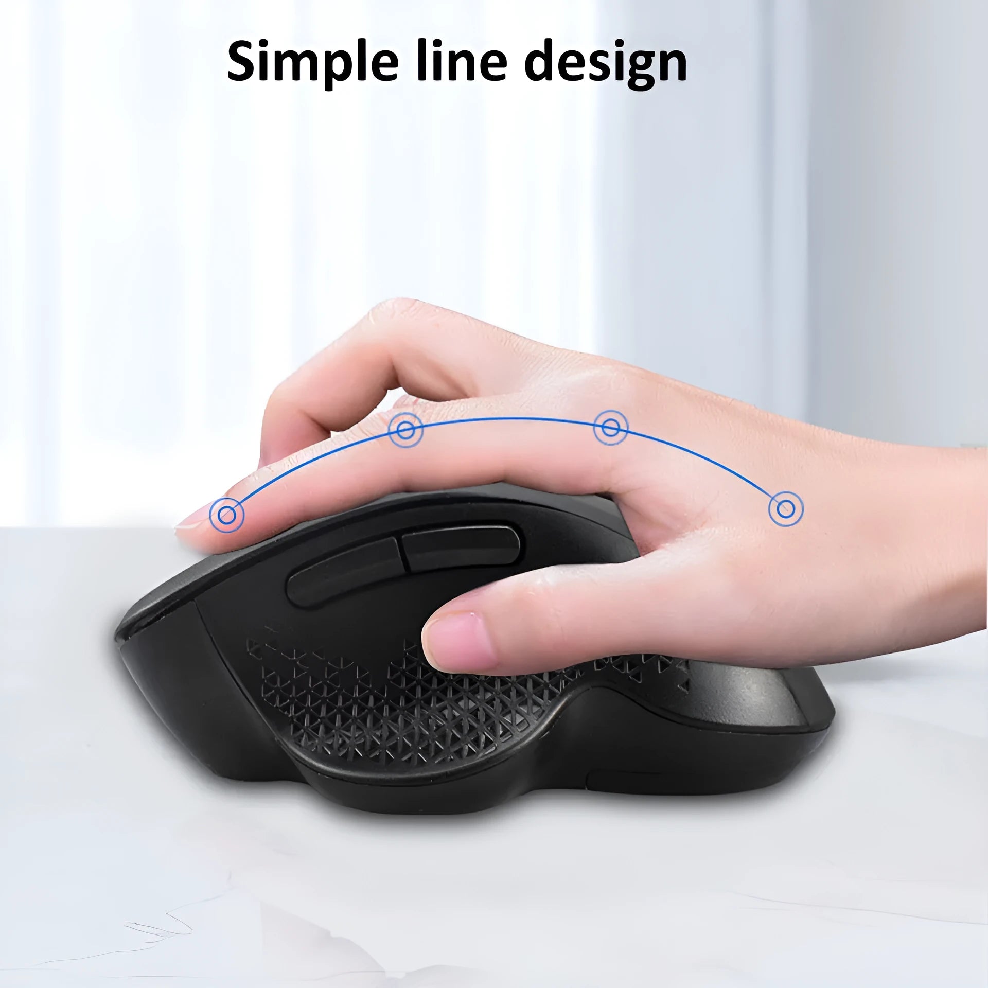 Compact grey wireless mouse with USB charging cable on a wooden desk next to a laptop.