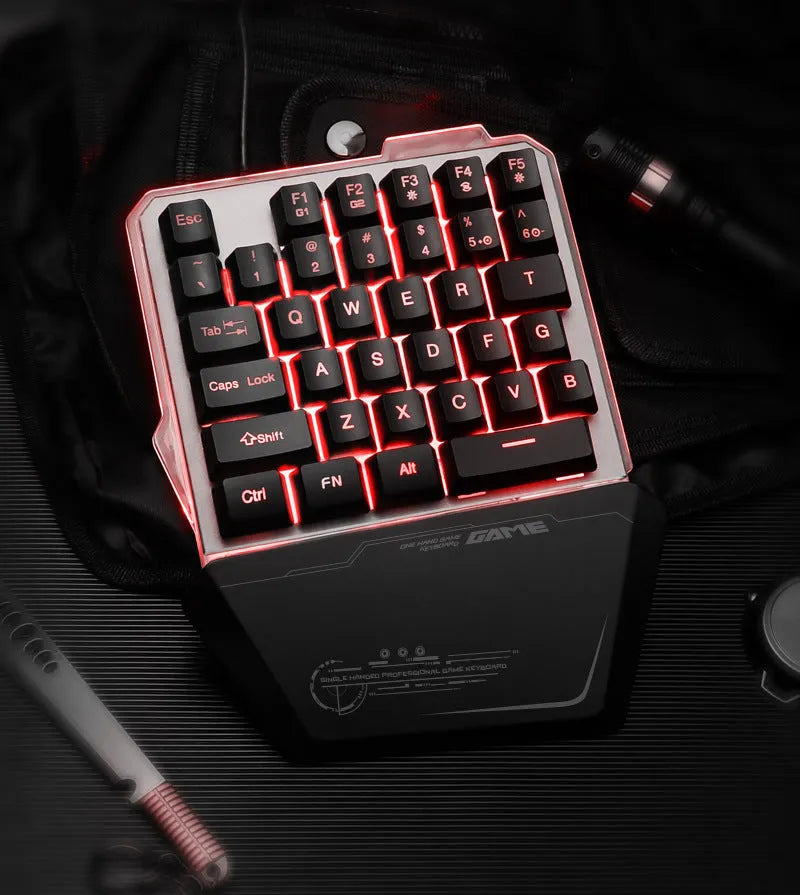 Black one-handed keyboard with RGB backlight and 1.8-metre USB cable on a desk