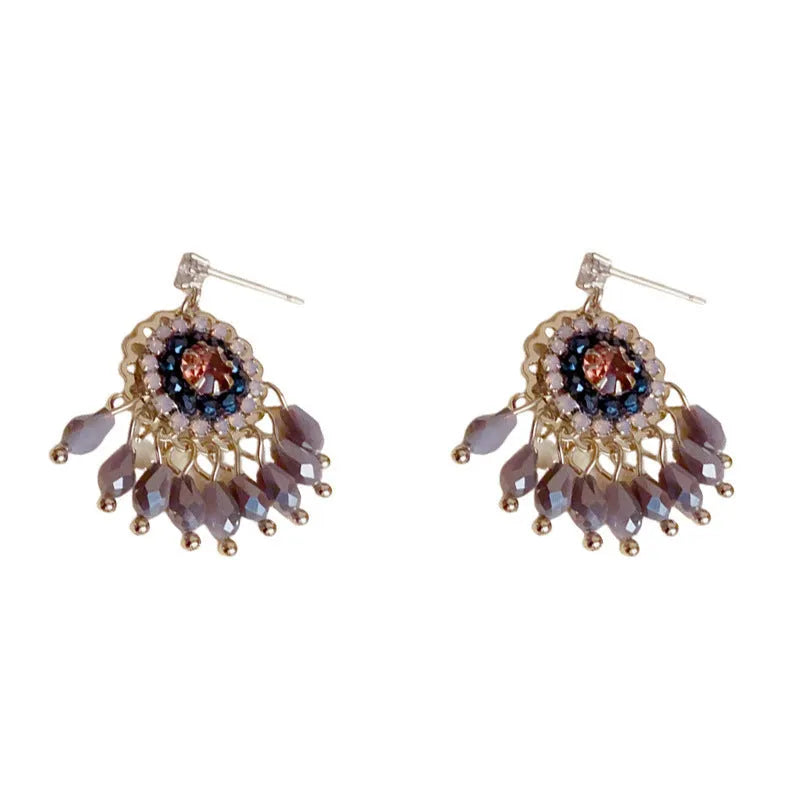 Gold plated geometric earrings with blue diamond-embedded crystals in tassel design