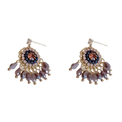 Gold plated geometric earrings with blue diamond-embedded crystals in tassel design