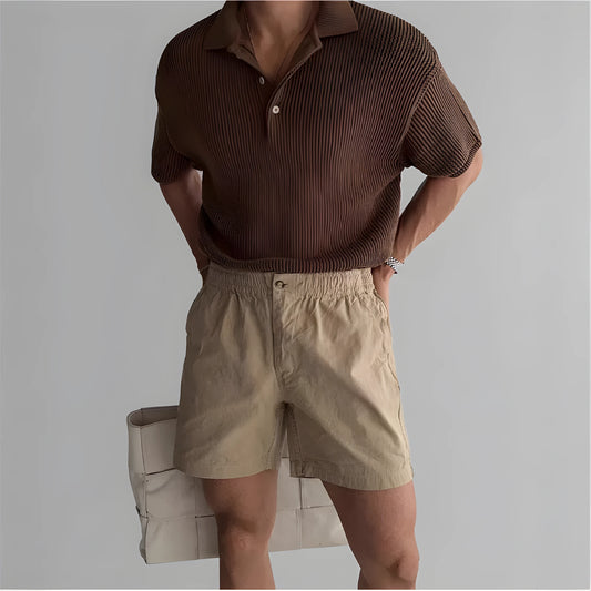 Men's loose-fit cotton sports shorts in black, shown on a hanger