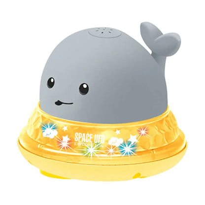 Automatic water-spraying whale bath toy with colourful lights floating in bath water.