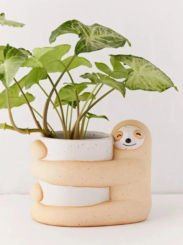 Ceramic sloth flower pot with drainage holes measuring 13.5cm height
