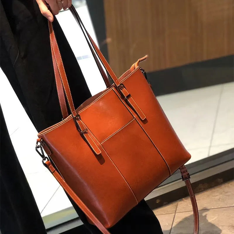 Brown genuine leather women's retro shoulder bag showing front view and organised interior pockets.