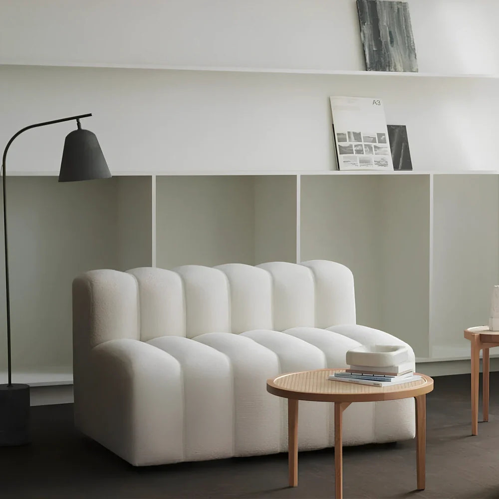 Off-white curved modular sofa with fleece fabric in corner configuration showing multiple connected pieces