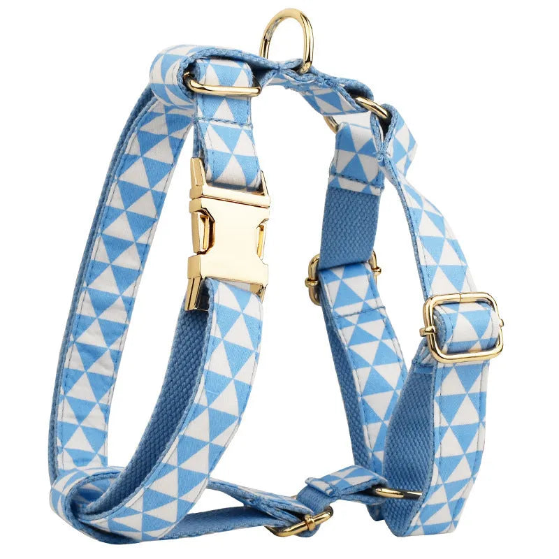 Blue cloth dog collar, leash, bow, and vest four-piece set with triangular metal ring, shown in a pet accessory bundle.