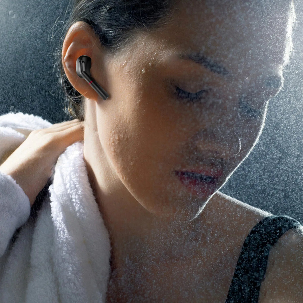 VV1 black and white Bluetooth earphones with a compact charging case on a table.