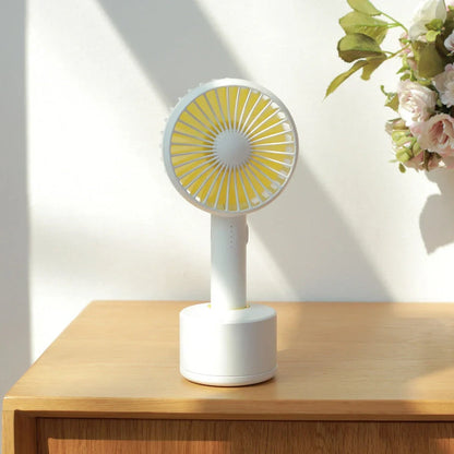 Blue shaking head handheld fan showing oscillating mechanism and USB charging port