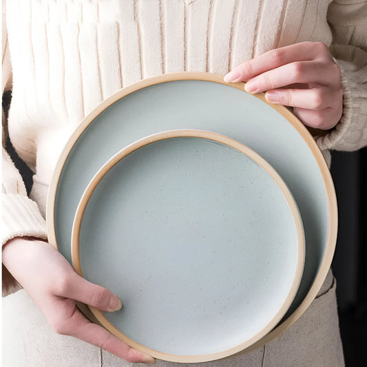 A blue matte-finish 10-inch ceramic dinner plate on a plain surface.