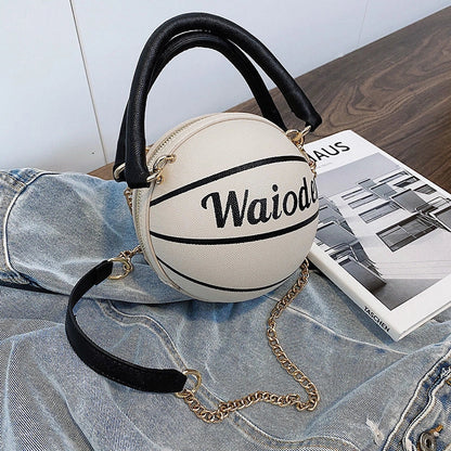 Basketball-shaped handbag with adjustable shoulder strap in pink, white, black, and brown