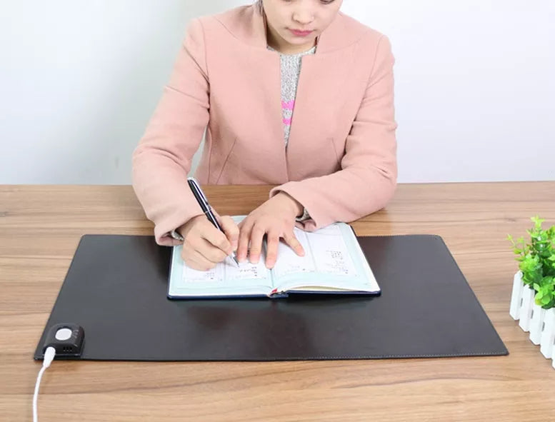 Two-stage Heating Desk Pad in black or pink, featuring quick warmth and waterproof design